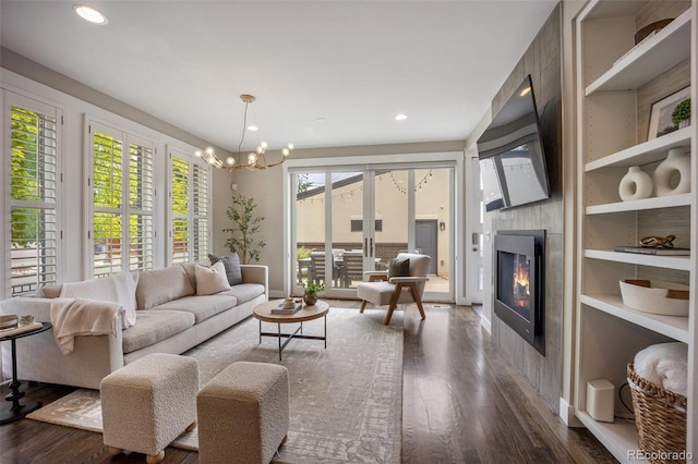 3690 W Byron Pl, Denver, CO 80211 - living area with a fireplace, dark wood-style floors, built in shelves, a chandelier, and recessed lighting