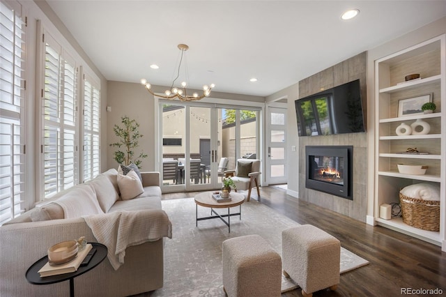 3690 W Byron Pl, Denver, CO 80211 - living area with built in shelves, a chandelier, wood finished floors, a tile fireplace, and recessed lighting