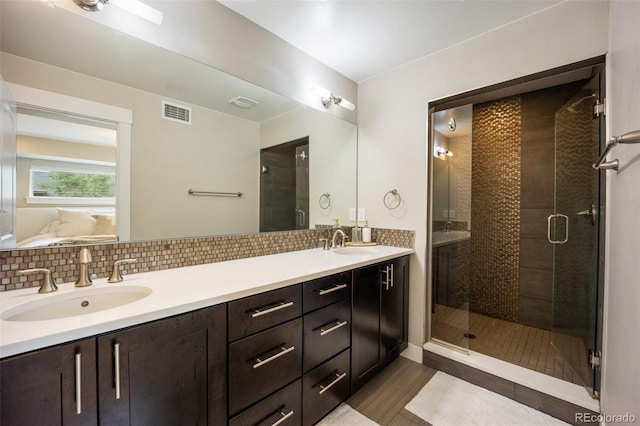 3690 W Byron Pl, Denver, CO 80211 - full bath featuring double vanity, a shower stall, ensuite bathroom, and backsplash