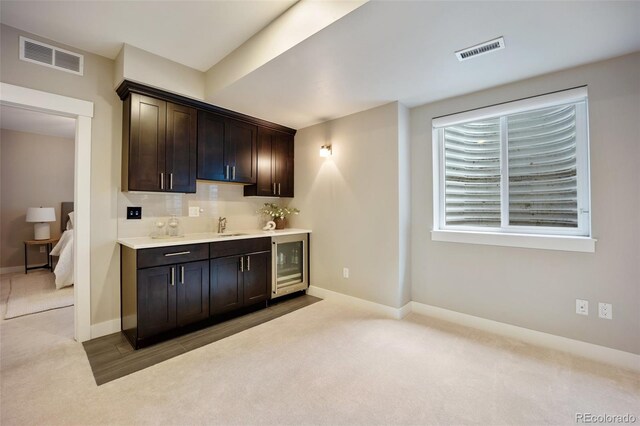 3690 W Byron Pl, Denver, CO 80211 - indoor wet bar with carpet flooring, beverage cooler, and backsplash