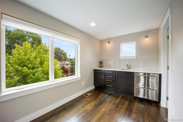 3690 W Byron Pl, Denver, CO 80211 - indoor wet bar featuring stainless steel dishwasher, dark wood-style floors, backsplash, and recessed lighting