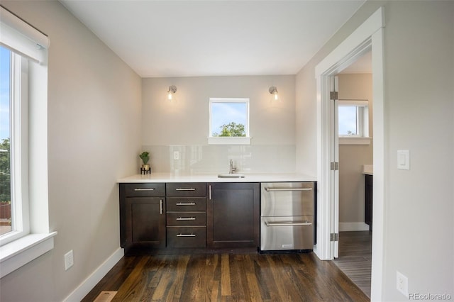 3690 W Byron Pl, Denver, CO 80211 - bar area featuring healthy amount of natural light, dark wood-type flooring, decorative backsplash, and dishwasher