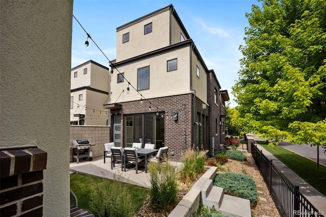3690 W Byron Pl, Denver, CO 80211 - back of property featuring brick siding, a patio, and stucco siding