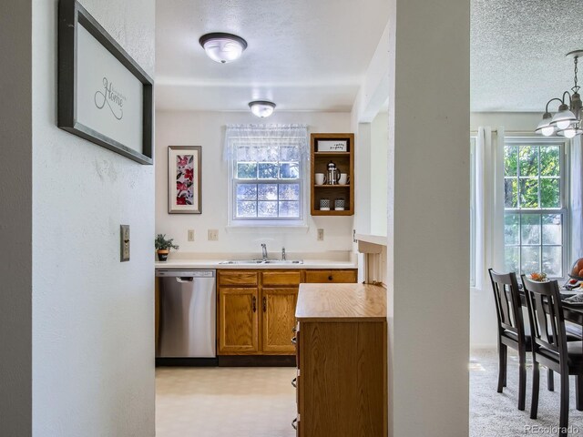 7700 N Depew St Unit 1518, Arvada, CO 80003 - bar with stainless steel dishwasher, a textured ceiling, a chandelier, and a textured wall