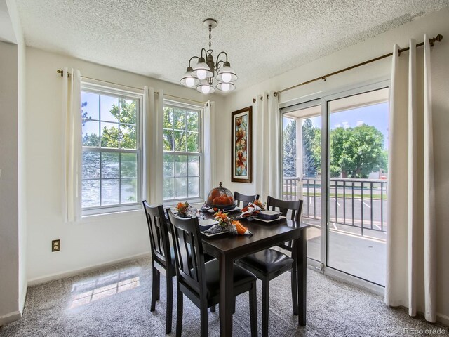 7700 N Depew St Unit 1518, Arvada, CO 80003 - dining space featuring a chandelier, plenty of natural light, a textured ceiling, and light carpet