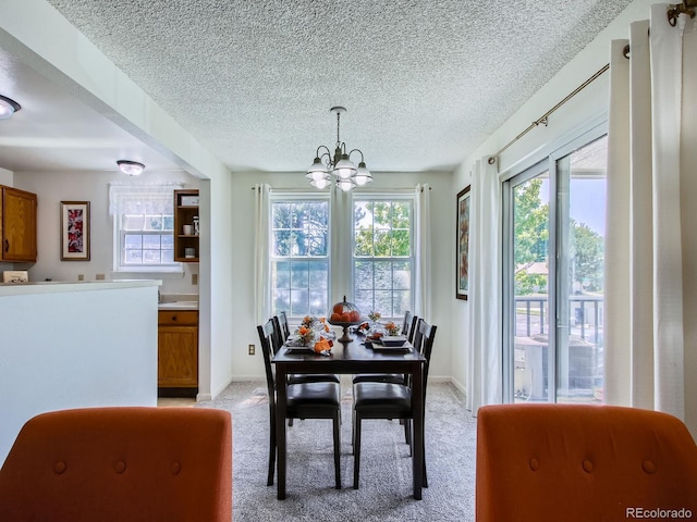 7700 N Depew St Unit 1518, Arvada, CO 80003 - dining area with a chandelier, light carpet, and a textured ceiling