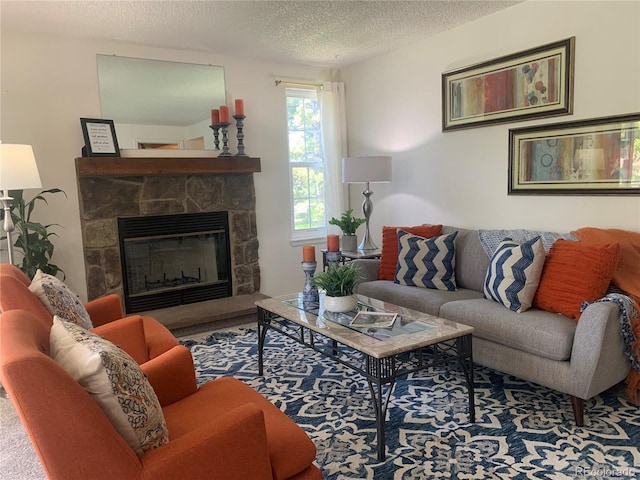 7700 N Depew St Unit 1518, Arvada, CO 80003 - living room featuring a textured ceiling, a stone fireplace, and carpet flooring