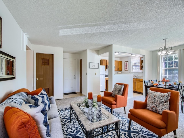 7700 N Depew St Unit 1518, Arvada, CO 80003 - living room featuring light colored carpet, a textured ceiling, and a chandelier