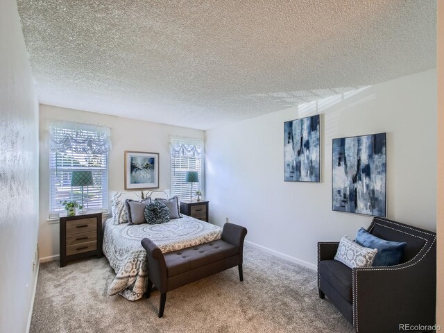 7700 N Depew St Unit 1518, Arvada, CO 80003 - bedroom with multiple windows, carpet flooring, and a textured ceiling