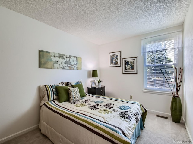 7700 N Depew St Unit 1518, Arvada, CO 80003 - bedroom featuring carpet floors and a textured ceiling