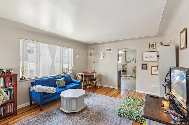 1856 S Garfield St, Denver, CO 80210 - living area featuring wood finished floors, ceiling fan, arched walkways, and baseboards