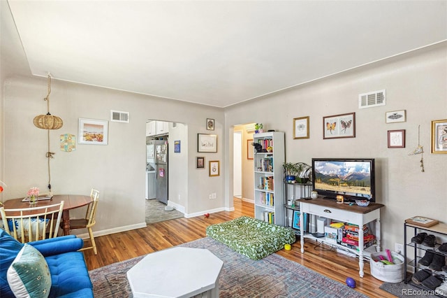 1856 S Garfield St, Denver, CO 80210 - living area with wood finished floors, baseboards, and arched walkways