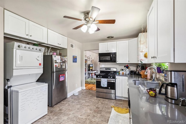 1856 S Garfield St, Denver, CO 80210 - kitchen with stainless steel appliances, stacked washer and clothes dryer, ceiling fan, a sink, and white cabinetry