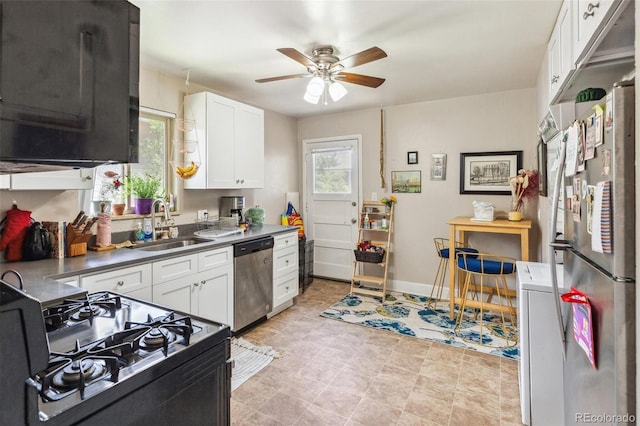 1856 S Garfield St, Denver, CO 80210 - kitchen with appliances with stainless steel finishes, a ceiling fan, white cabinetry, and a sink