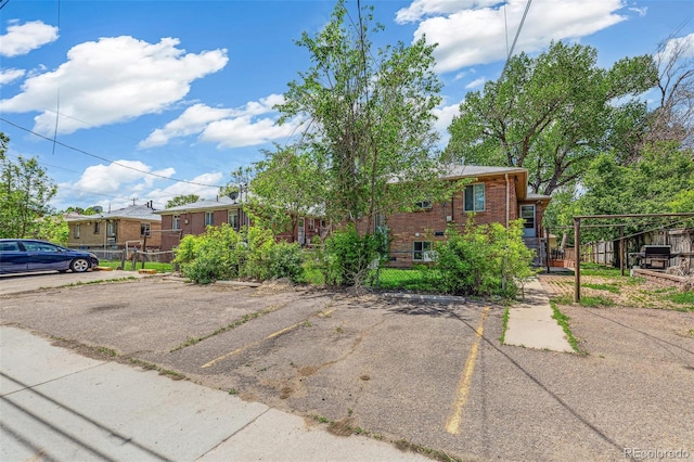1856 S Garfield St, Denver, CO 80210 - view of front of property featuring uncovered parking and brick siding