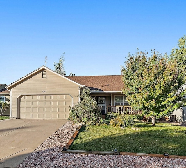 single story home with a garage, concrete driveway, covered porch, and a front yard