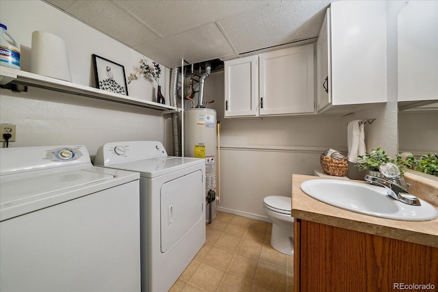 laundry area featuring gas water heater, laundry area, a sink, baseboards, and washer and dryer