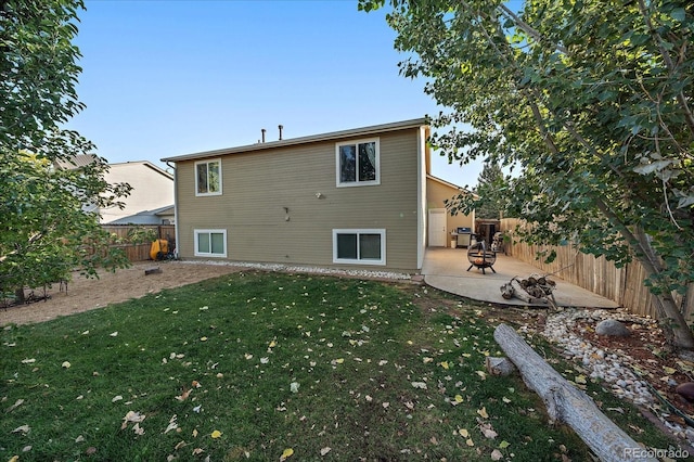 back of house with an outdoor fire pit, a lawn, a patio, and fence private yard