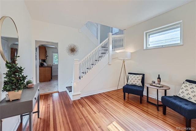 2854 Eliot St, Denver, CO 80211 - living area with stairs, wood-type flooring, arched walkways, and a healthy amount of sunlight
