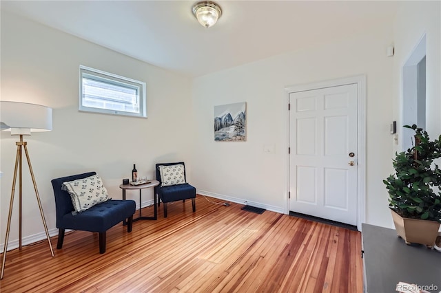 sitting room with wood-type flooring