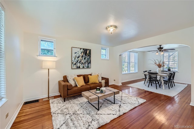 living room with hardwood / wood-style floors, ceiling fan, and a healthy amount of sunlight