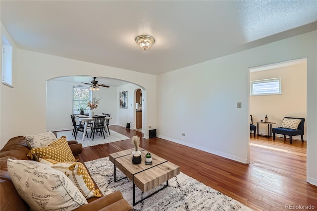 2854 Eliot St, Denver, CO 80211 - living room with arched walkways, baseboards, a ceiling fan, and wood finished floors