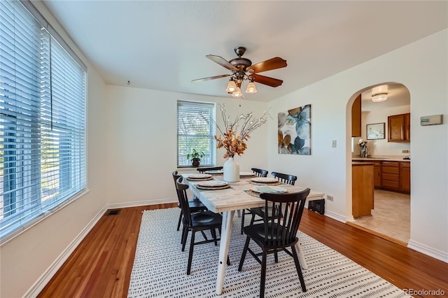 dining space with light hardwood / wood-style floors and ceiling fan