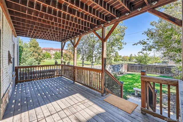 wooden terrace featuring a yard