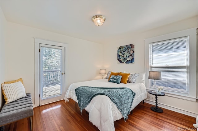 2854 Eliot St, Denver, CO 80211 - bedroom featuring wood finished floors, baseboards, access to exterior, and multiple windows