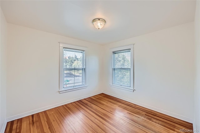 spare room featuring a wealth of natural light and light wood-type flooring