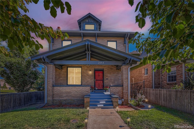 view of front of property with a lawn