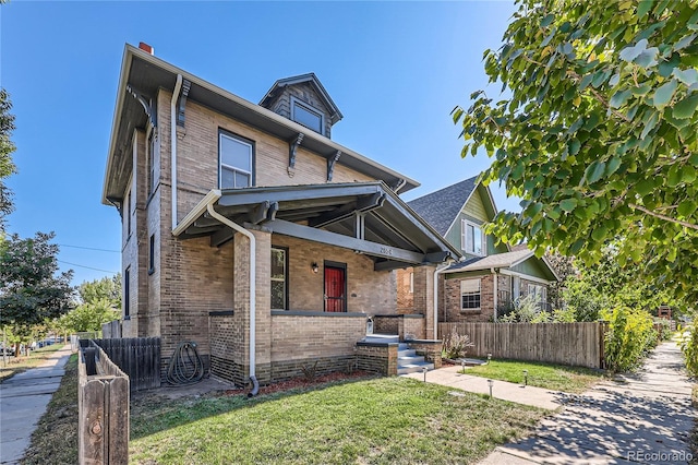 2854 Eliot St, Denver, CO 80211 - american foursquare style home with a front lawn, brick siding, and fence