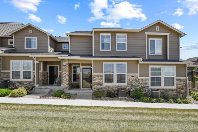 view of front of property featuring central AC and a front lawn