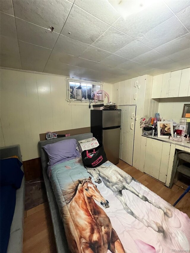 2655 Pontiac St, Denver, CO 80207 - bedroom with freestanding refrigerator and light wood-style floors