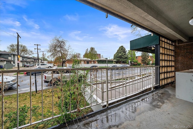 view of patio with a balcony and a residential view