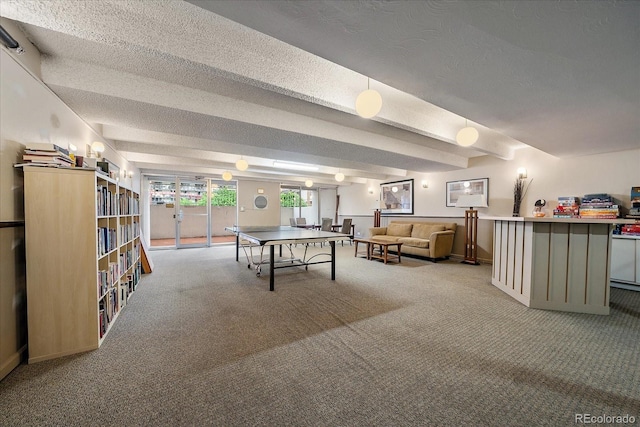 game room featuring carpet, beam ceiling, a textured ceiling, and baseboards