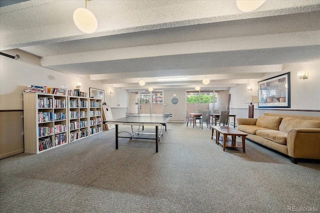 rec room with carpet, beamed ceiling, and a textured ceiling