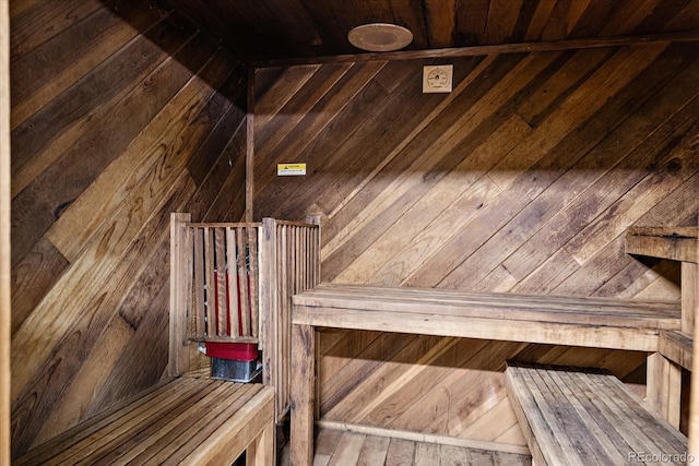 relaxing sauna / steam room with wood walls and wood ceiling