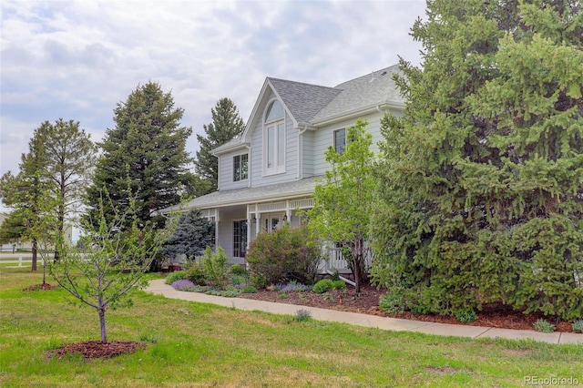 31 N Algonquian St, Aurora, CO 80018 - view of front of home with a front lawn and a shingled roof