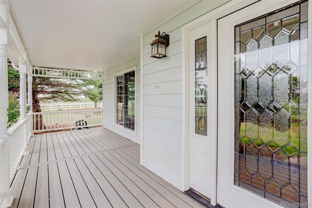 31 N Algonquian St, Aurora, CO 80018 - wooden terrace with covered porch