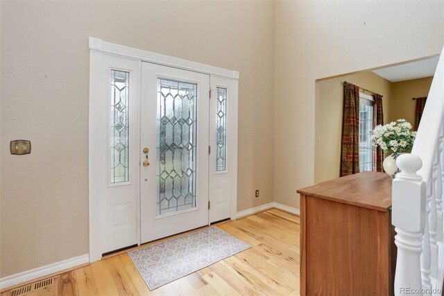 31 N Algonquian St, Aurora, CO 80018 - entryway with healthy amount of natural light, light wood-style flooring, and baseboards