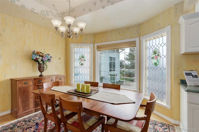 31 N Algonquian St, Aurora, CO 80018 - dining area with light wood-type flooring, a chandelier, and baseboards