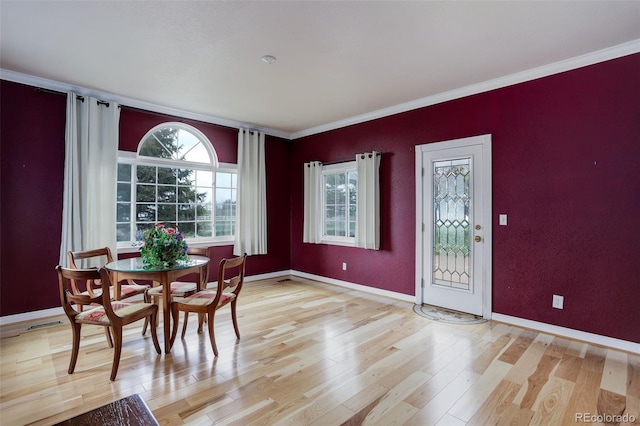 31 N Algonquian St, Aurora, CO 80018 - dining room with light wood-style floors, crown molding, and baseboards