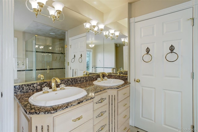 31 N Algonquian St, Aurora, CO 80018 - full bathroom featuring a chandelier, a shower stall, and double vanity