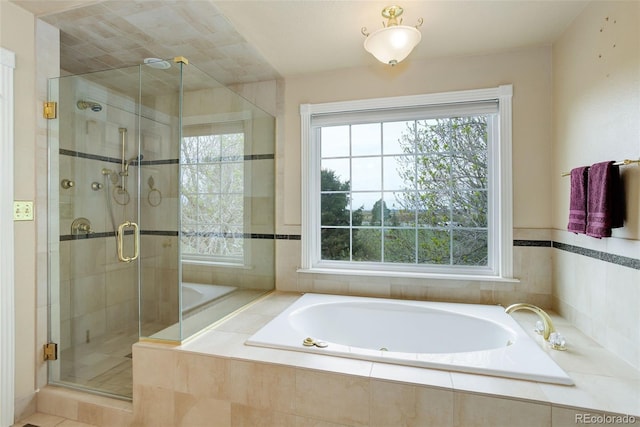 31 N Algonquian St, Aurora, CO 80018 - bathroom featuring a bath and a stall shower