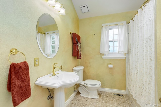 31 N Algonquian St, Aurora, CO 80018 - bathroom featuring toilet, baseboards, tile patterned floors, and vaulted ceiling