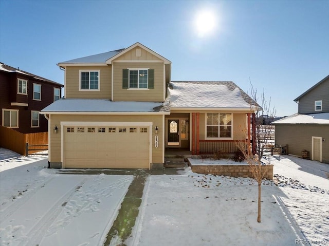 view of property with covered porch and a garage