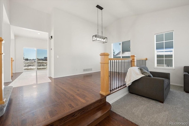 living area with dark hardwood / wood-style floors and vaulted ceiling