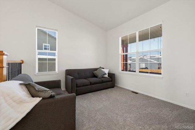 living room with carpet flooring and vaulted ceiling