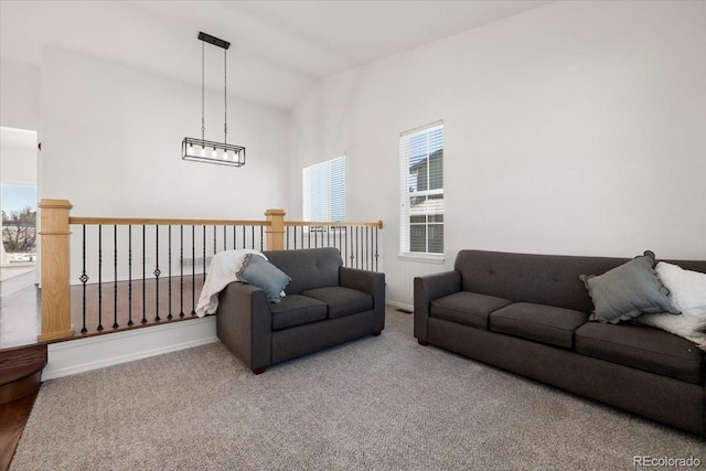 carpeted living room with vaulted ceiling